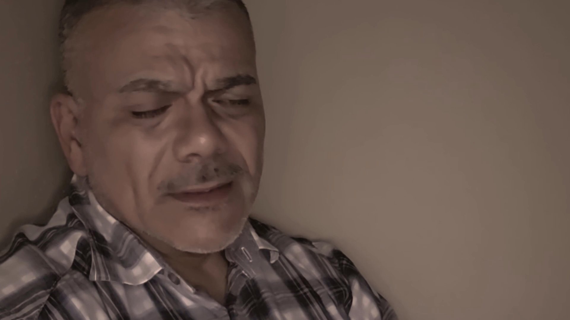 A middle-aged man speaks directly to the camera, sharing a personal narrative with expressive facial gestures. The setting is intimate, focusing on his candid delivery and emotional engagement.