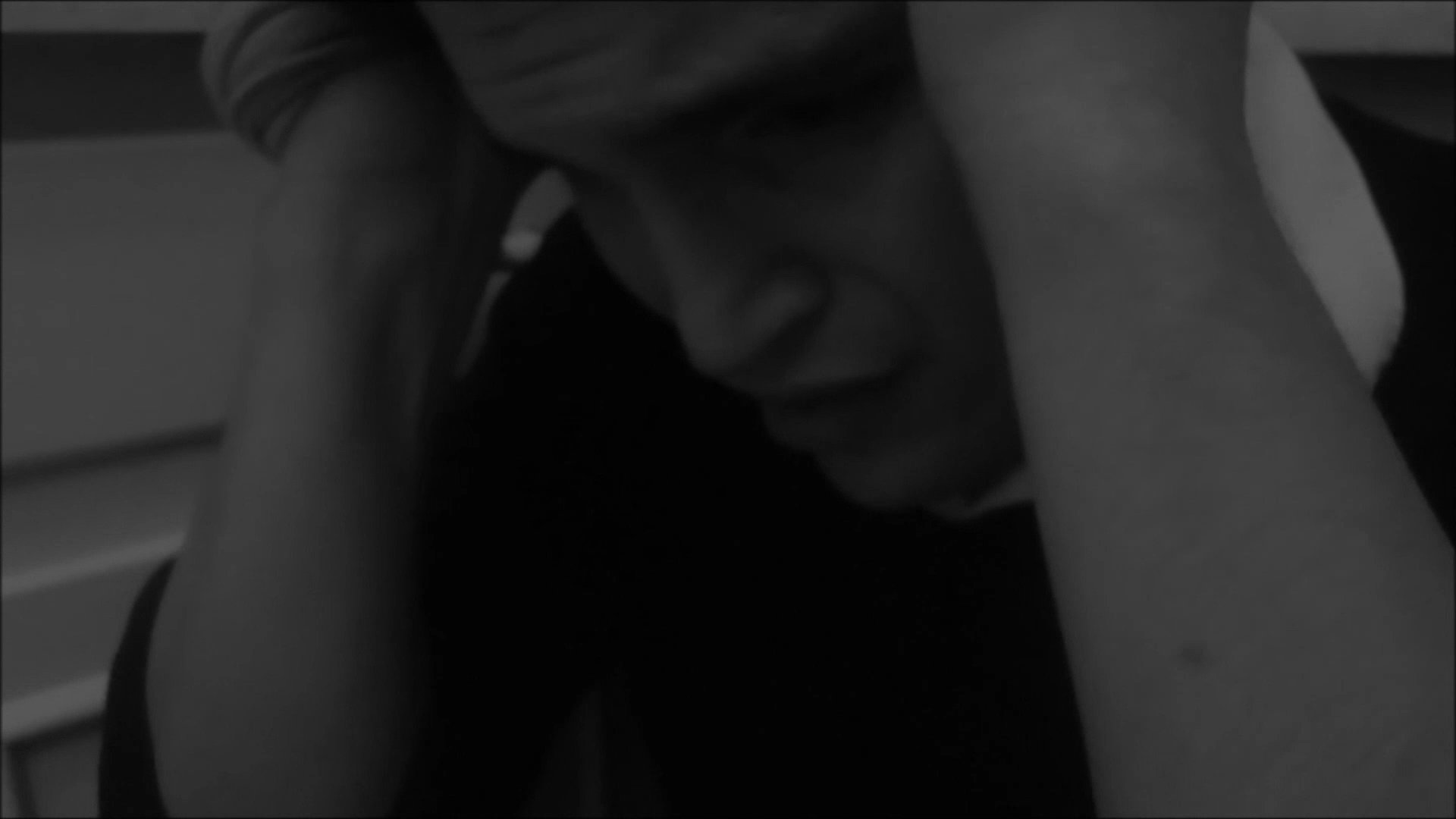 A man exhibits signs of intense mental anguish and psychological distress while pacing in a domestic environment and later retreating to a seated position in isolation. The visual sequence conveys a state of profound emotional overwhelm.