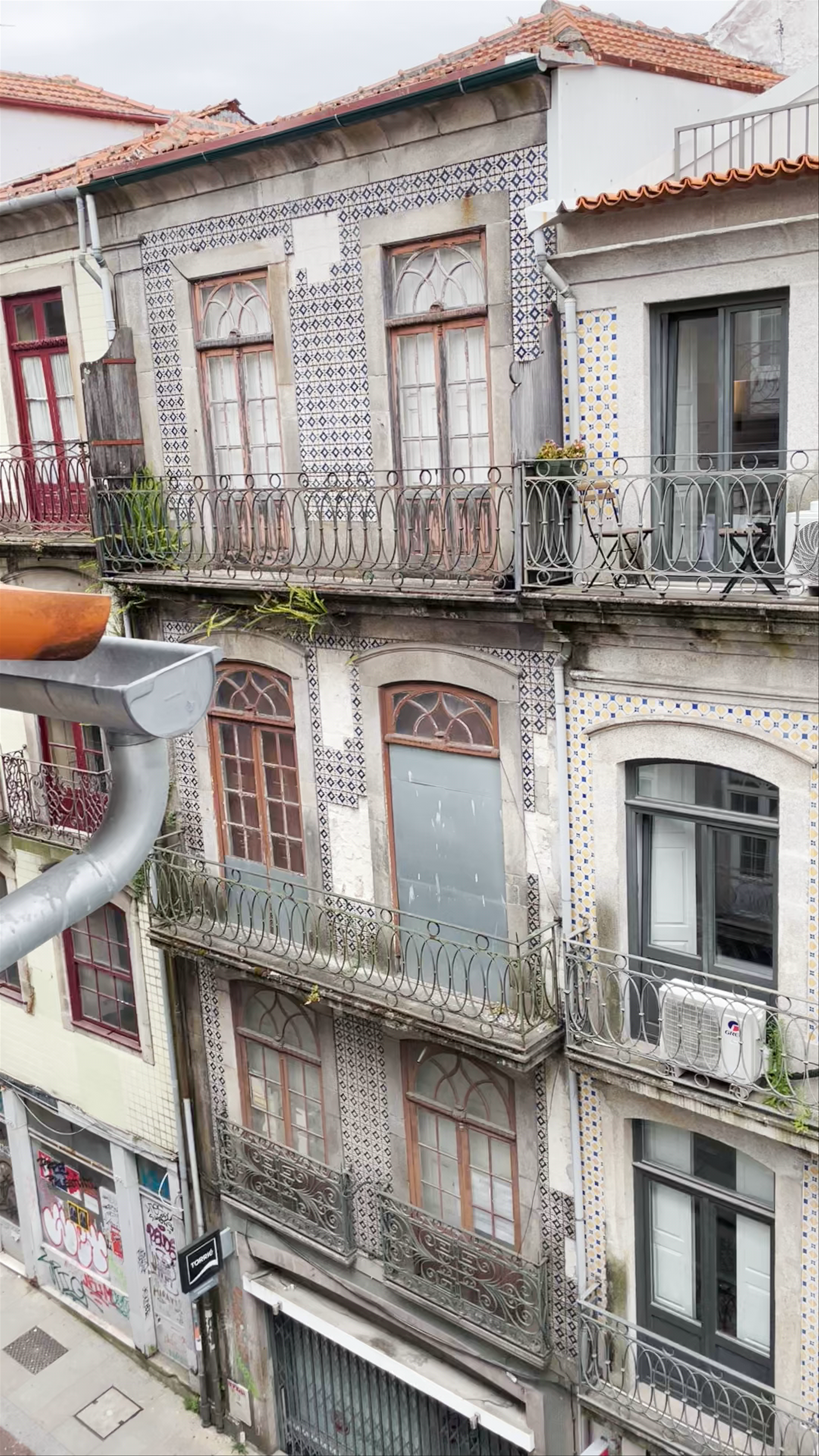 Charming Streets of Porto: A Window View of Historic Azulejo Facades
