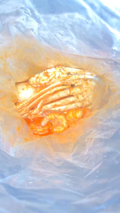 The Kickin’ Crab - The angle makes the bag look small but it was a good portion of food. - Seafood Near Me - Grand Prairie, Texas
