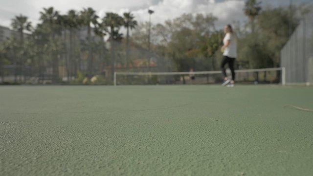 Tennis balls rolling on the court