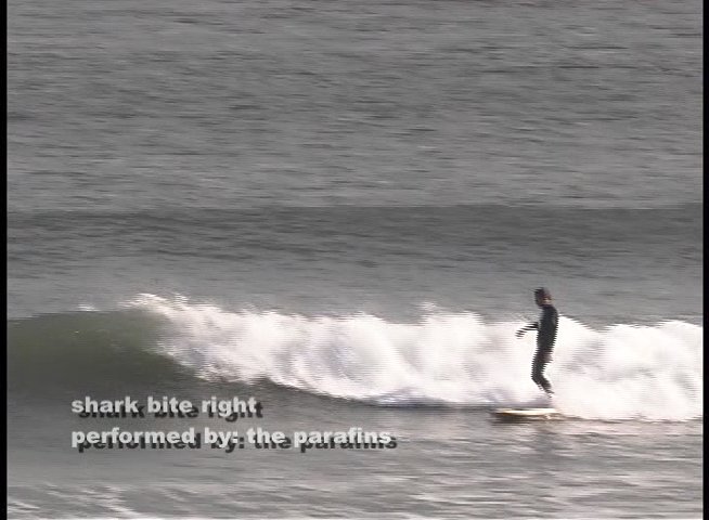 A surfer skillfully navigates breaking ocean waves while wearing a wetsuit. The sequence captures the surfer performing maneuvers across multiple rolling swells.