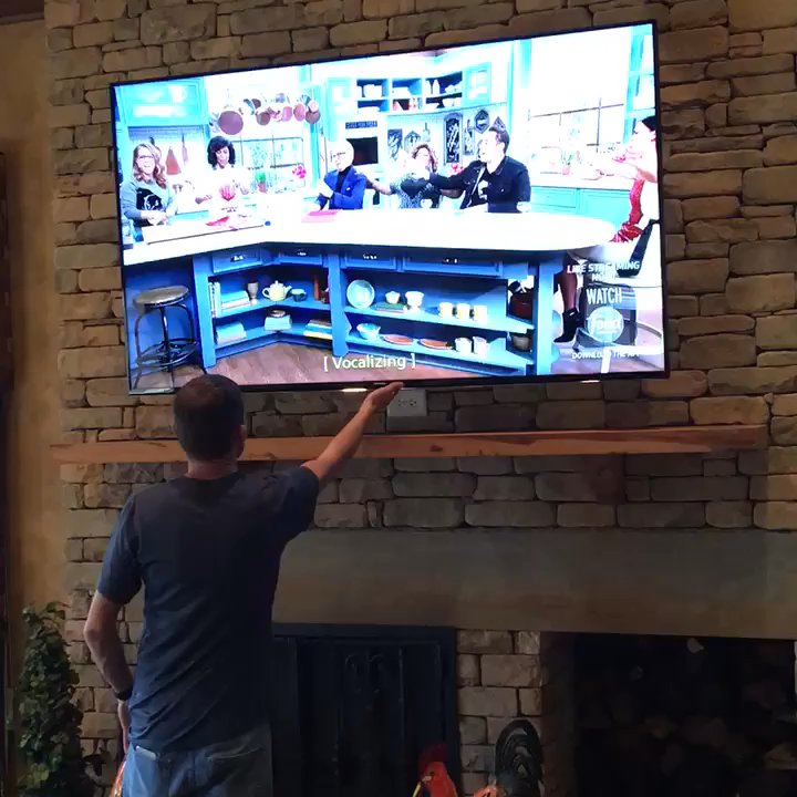 Sound & Video Solutions - 75" TV on drop down arm makes for perfect viewing, these guys are really exceptional at what they do - Home Theatre Installation Near Me