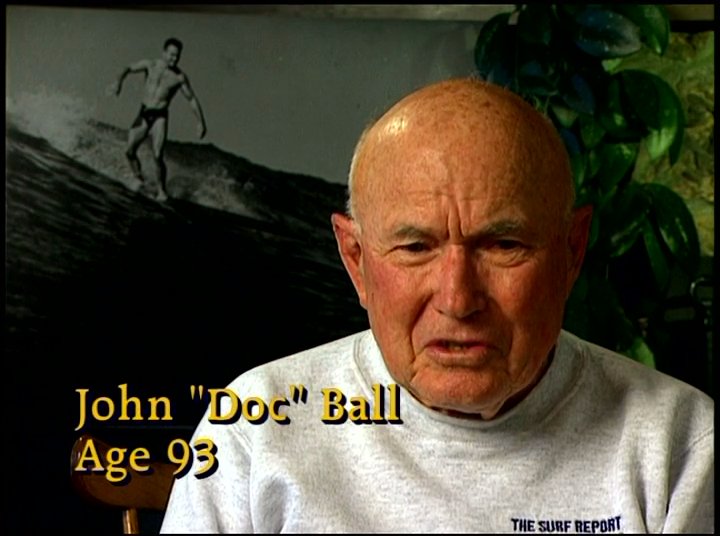 Elderly surfers demonstrate enduring athletic vitality as they ride ocean waves, complemented by personal commentary from John Doc Ball.