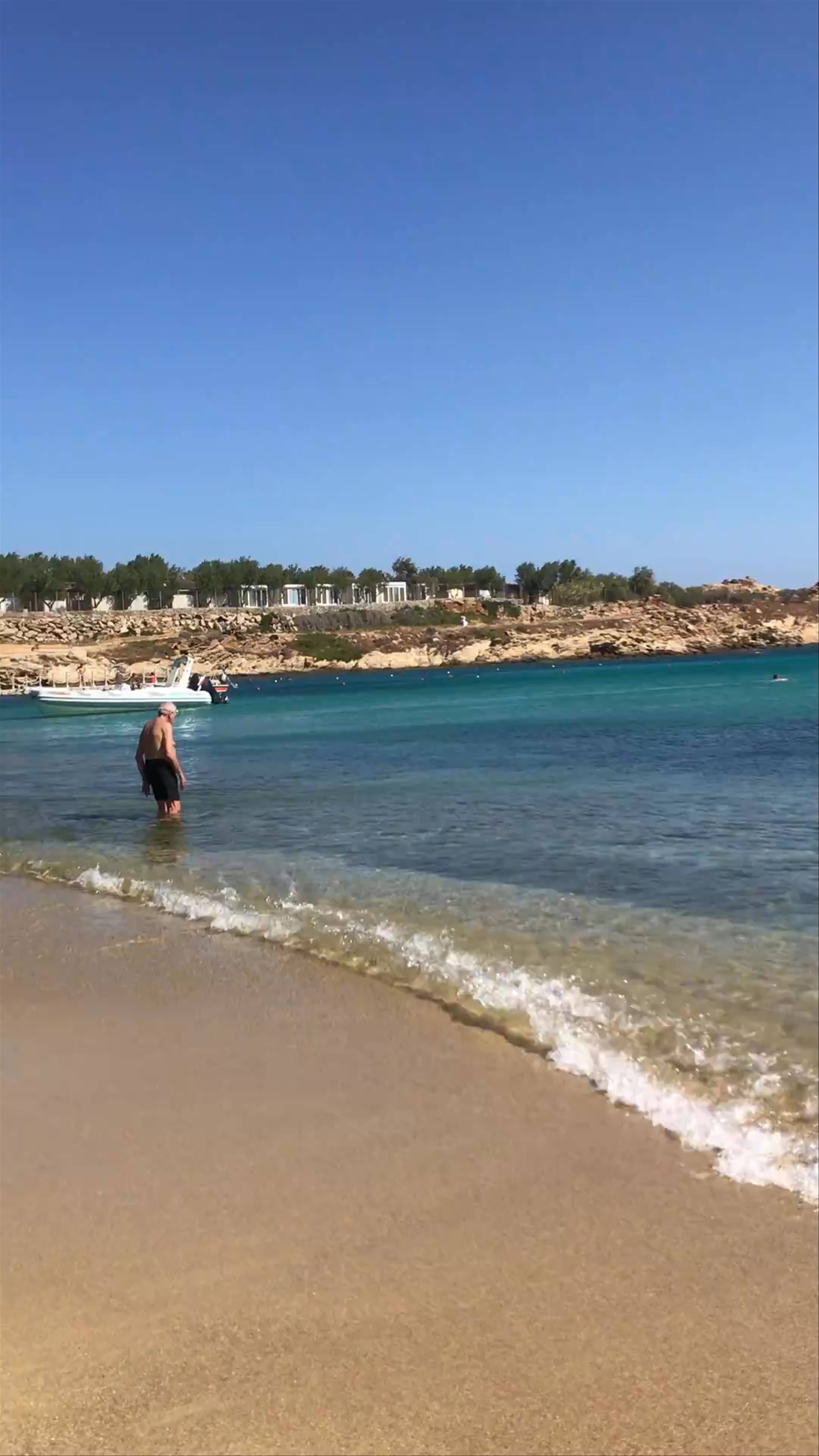 Sunny Day at Paraga Beach, Greece: Crystal Clear Waters and Golden Sands