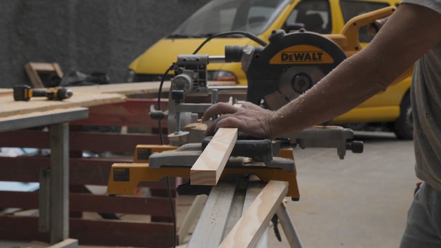 Carpenter works with a miter saw