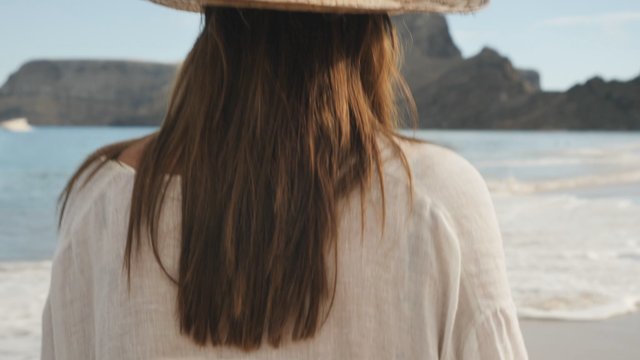 Woman wearing straw hat on the beach
