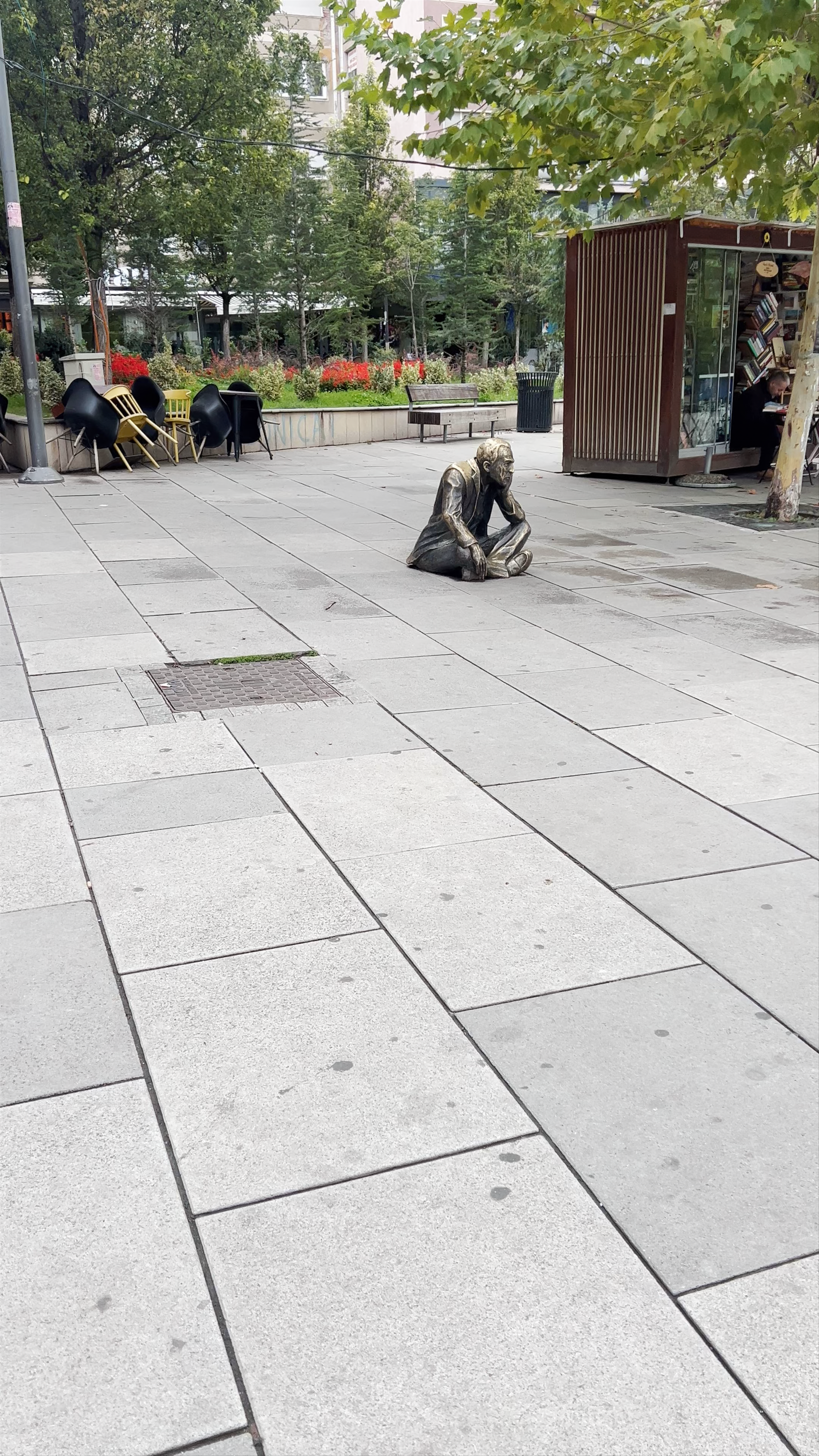 Sitting Man Sculpture at Nënë Tereza Square, Pristina