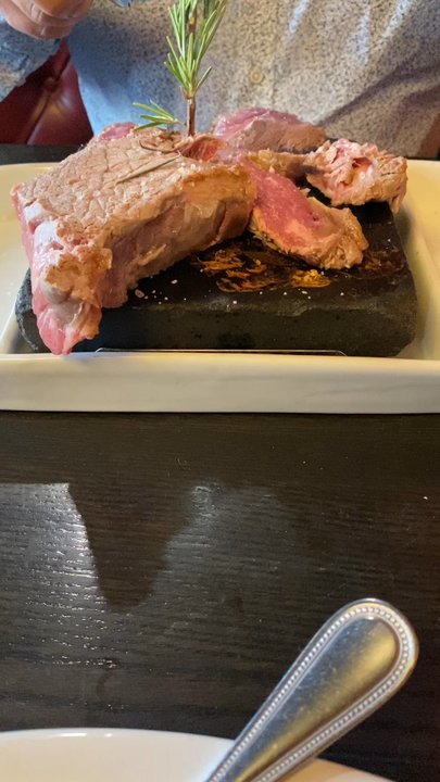 Black Rock Steakhouse - NY 10 Oz. NY Strip Steak cooking on the black rock - Steakhouses Near Me - Springfield, Vermont