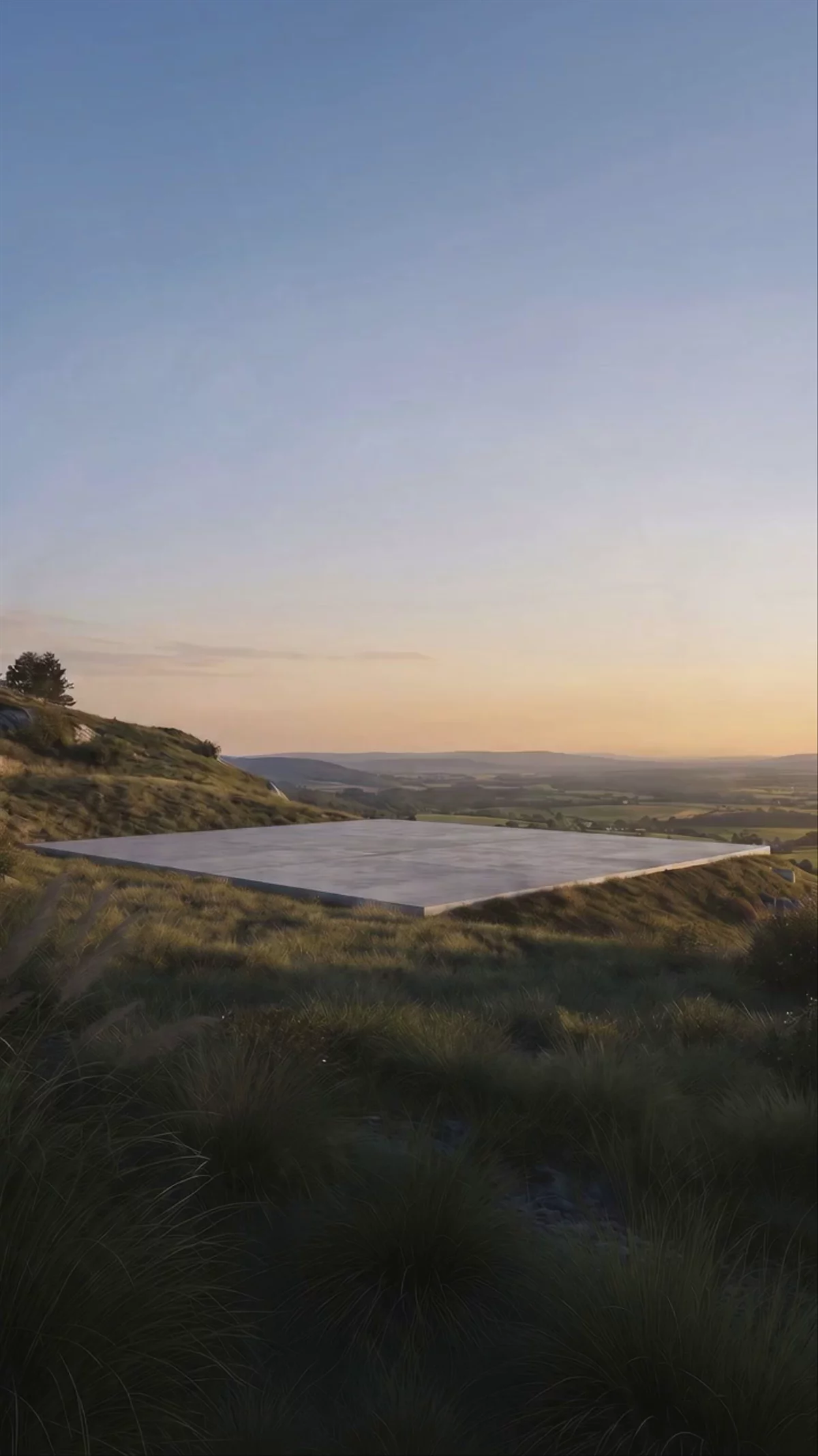 The same house as an exposed timber frame on its concrete slab, at sunset