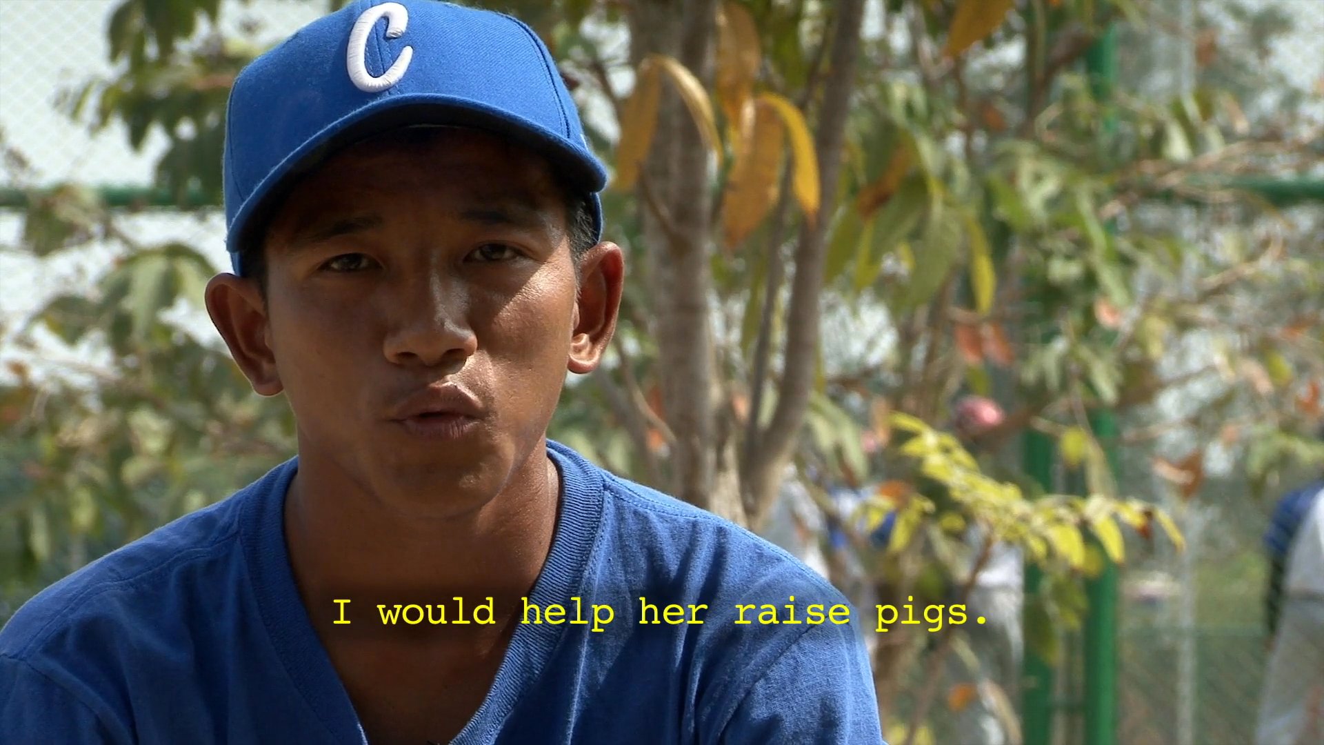 A baseball player reflects on his background, family life, and his introduction to the sport during a personal interview on a practice field.