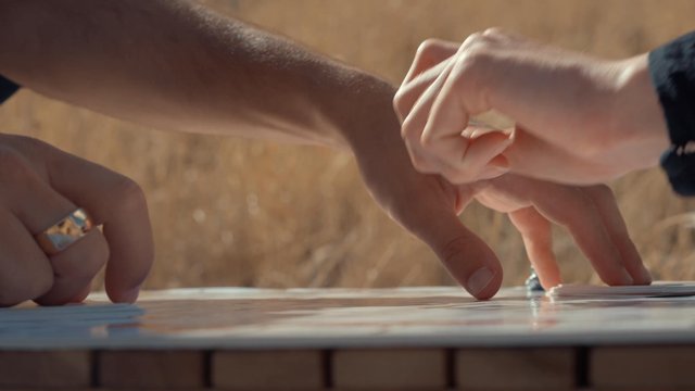 A couple playing a board game outdoors