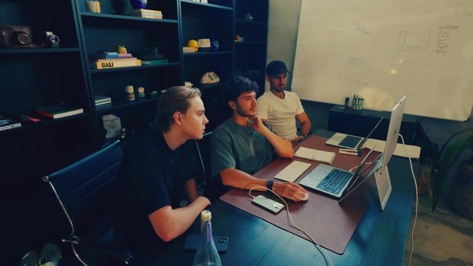 Isaac Hetzroni with the Imperium team at his desk during the install