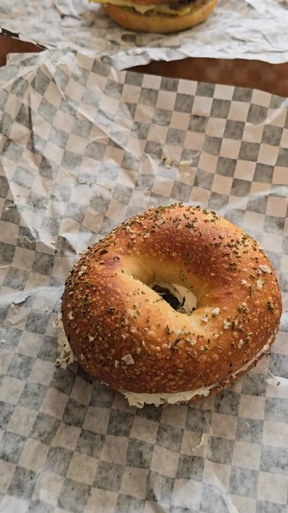 Bloom Bistro & Grocery - Rosemary sea salt bagel with spinach & artichoke schmear and breakfast bagel. - Bagels Near Me - Seattle, Washington