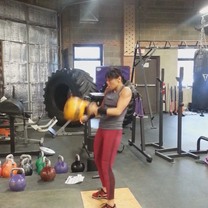 Evolution Strength and Conditioning - Coach Linda training the kettlebell clean and jerk with 16kg - Trainers Near Me - Chicago, Illinois