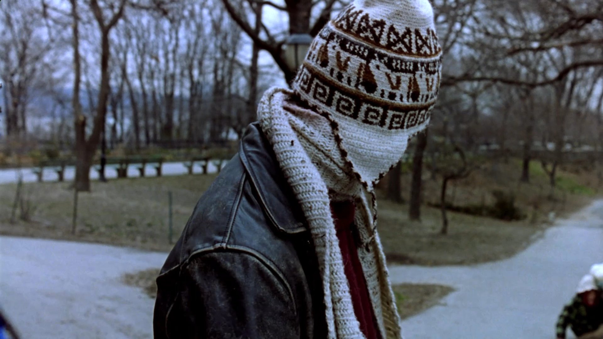 Individuals engage in quiet observation and conversation across varied settings, transitioning between an intimate limousine interior, a miniature dioramic park landscape, and a cold winter day on a bridge. The sequence juxtaposes stylized model environments with authentic human interaction.