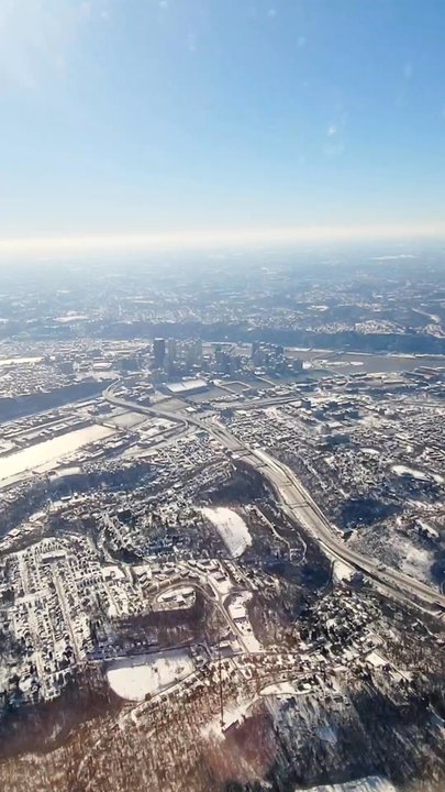 American Airlines - Flying over a snowy downtown Pittsburgh on the approach to PIT - Airlines Near Me - Pittsburgh, Pennsylvania
