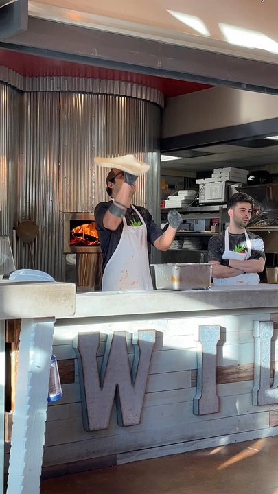 Wild Tomato - Pizza guys tossing crust - Pizza Near Me - Fish Creek, Wisconsin