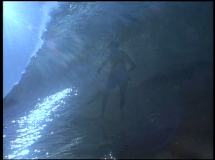Renowned surfers Woody Brown and Rabbit Kekai demonstrate their enduring skill and athleticism by riding waves in the ocean.