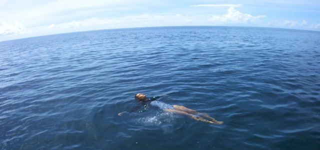 Woman floating in the ocean