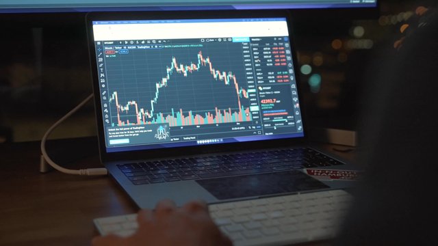 A businessman working on a stock market trading platform