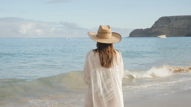 Woman wearing a hat on a beach