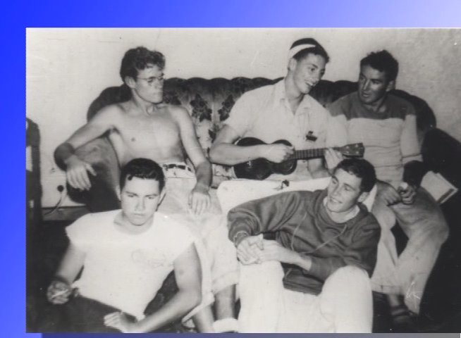 An individual provides commentary while presenting black-and-white archival photographs of young men posing and socializing. The sequence shifts from the narrator to various vintage scenes depicting group activities, including a beach setting near a pier.