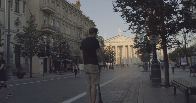 Scooter riding down Gedinimo Avenue in Vilnius