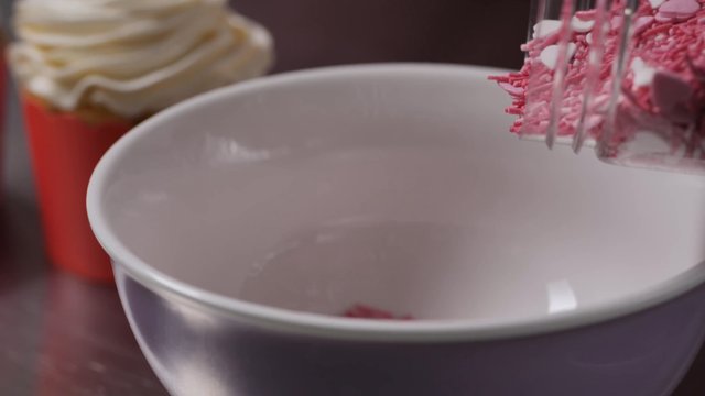 Pouring sprinkles in a bowl
