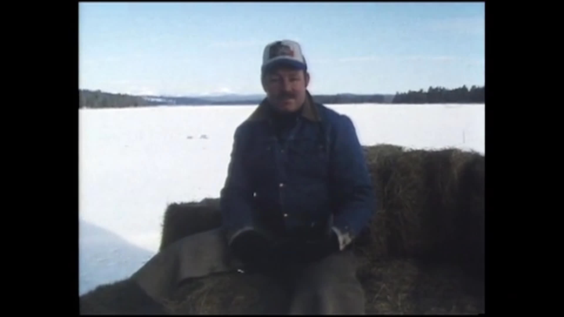 On a snowy ranch, people handle hay bales and tend to livestock near a pickup truck. A rancher explains that young people should focus on feeding calves and colts and doing light ranch work.