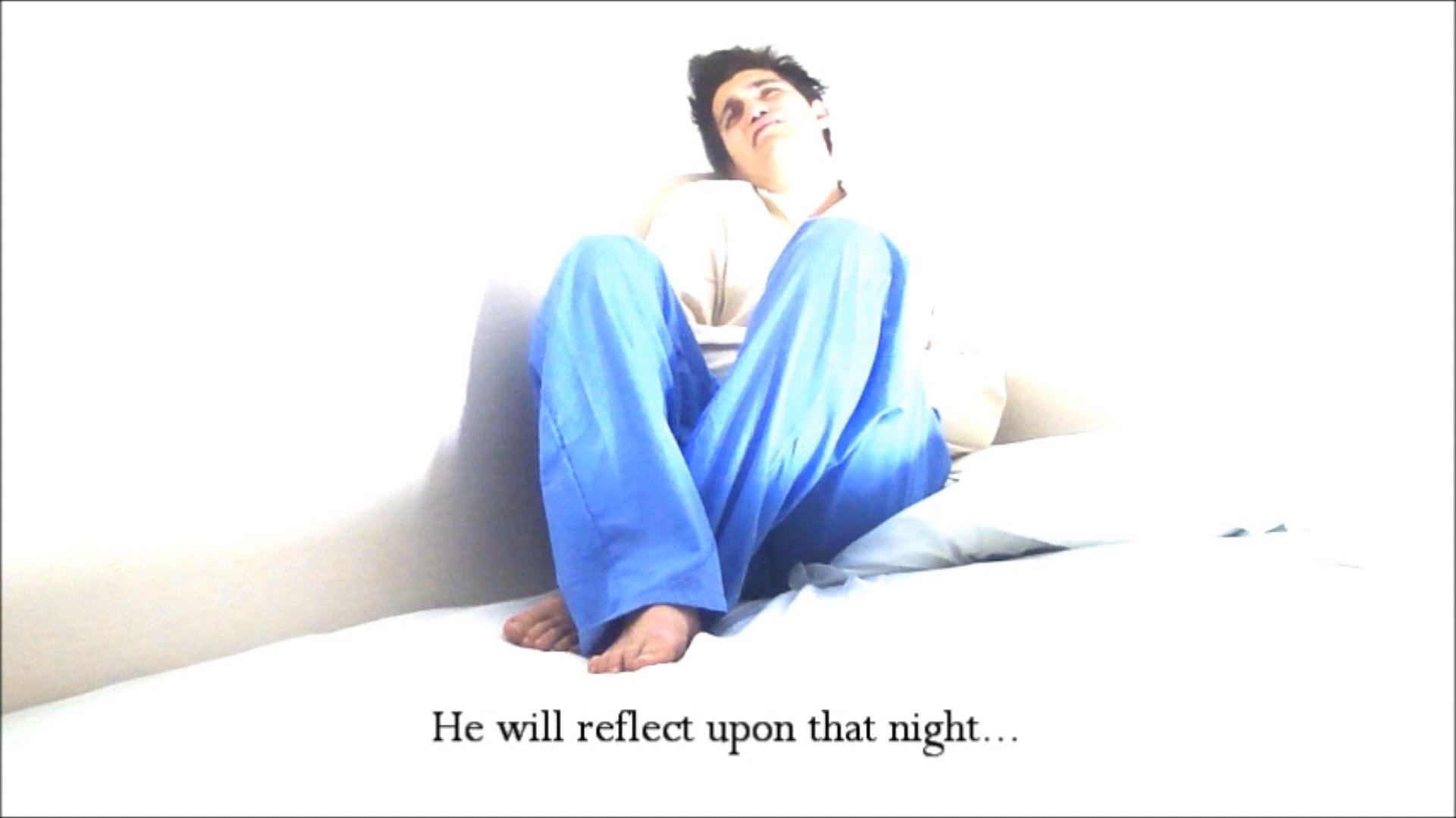 A man sits alone on a bed in a brightly lit room, lost in contemplation about past events. He struggles with his emotions while reflecting on the lasting impact of a significant night.