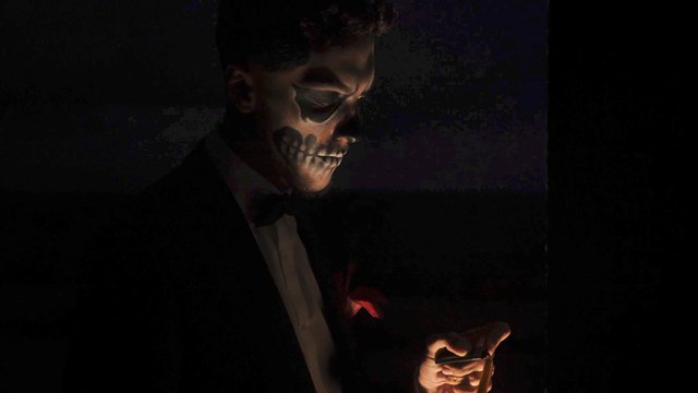 Halloween man lights a candle