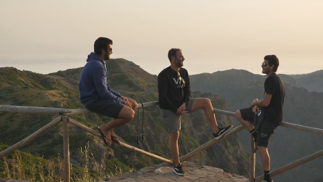 Friends talking on a mountain top 