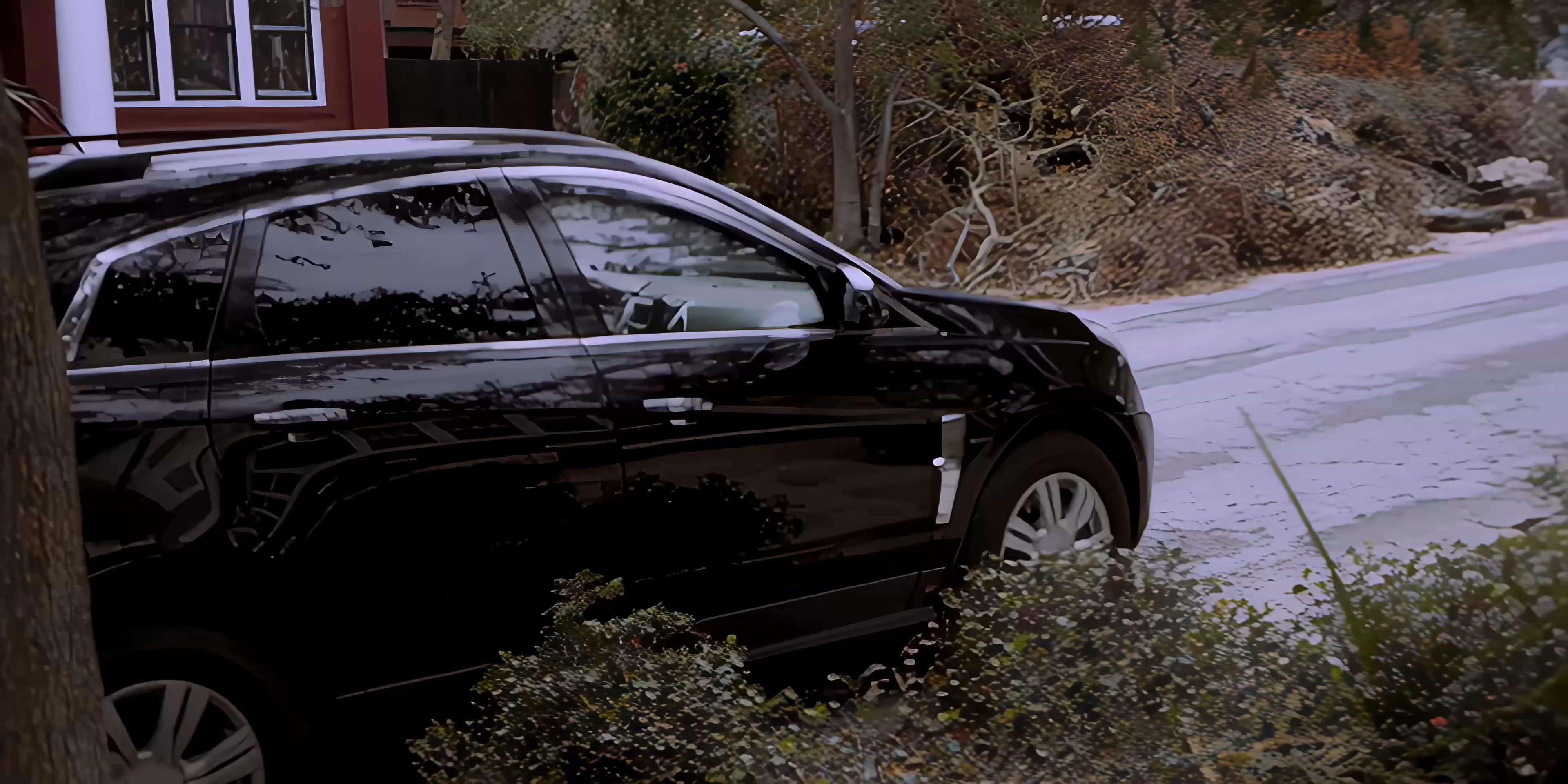 A driver transports a professional passenger through a residential neighborhood in a Cadillac SUV. The two men exchange brief conversation while the vehicle navigates local streets.