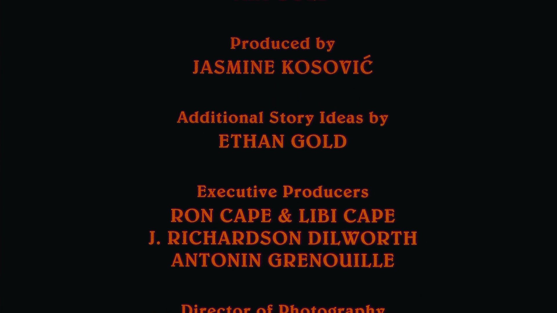 Orange text scrolls vertically against a solid black background, listing the production team, directors, and key contributors involved in the project.