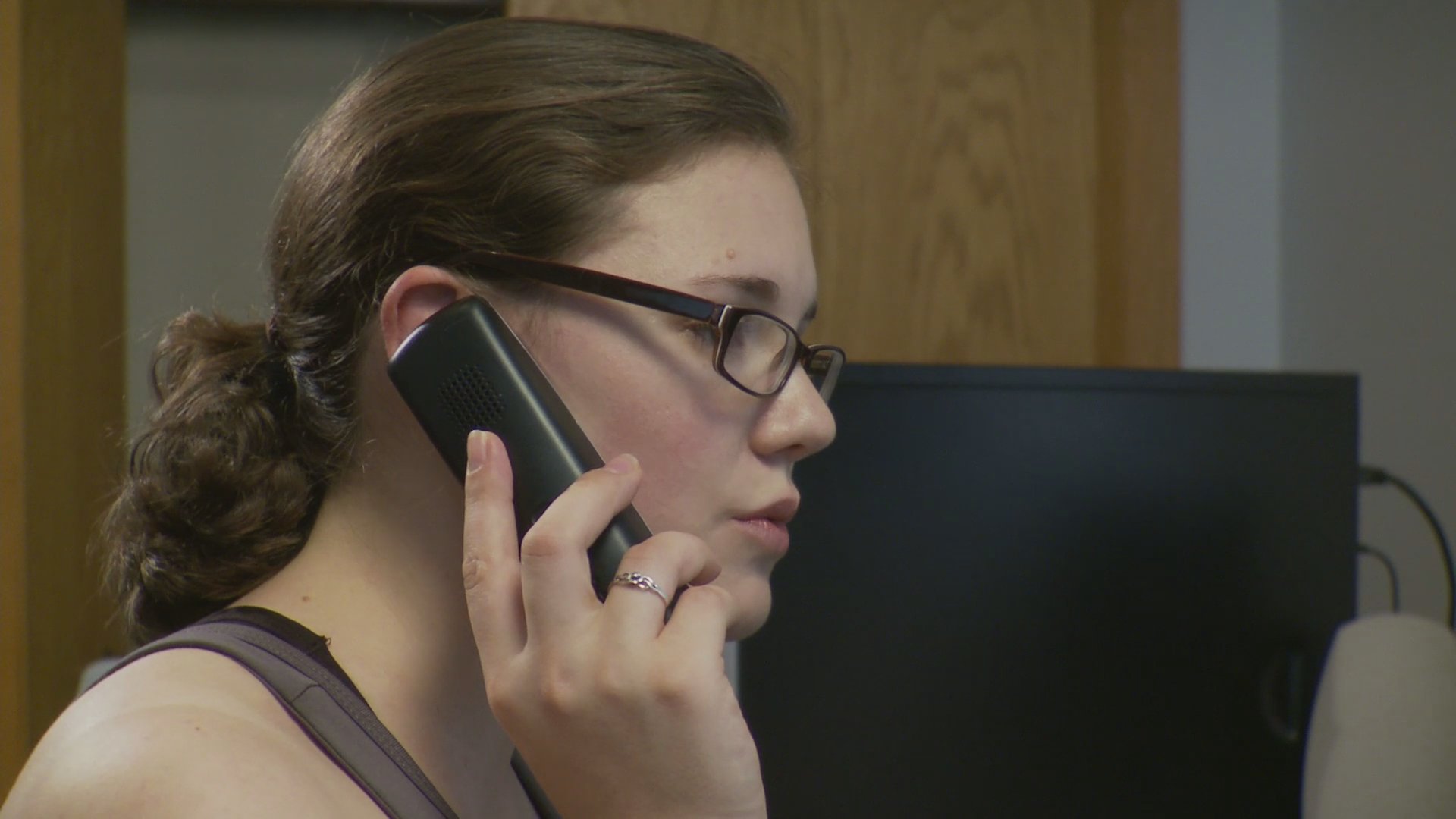 Two individuals engage in a focused, remote telephone conversation from their respective environments. The exchange alternates between their reactions and dialogue as they communicate.