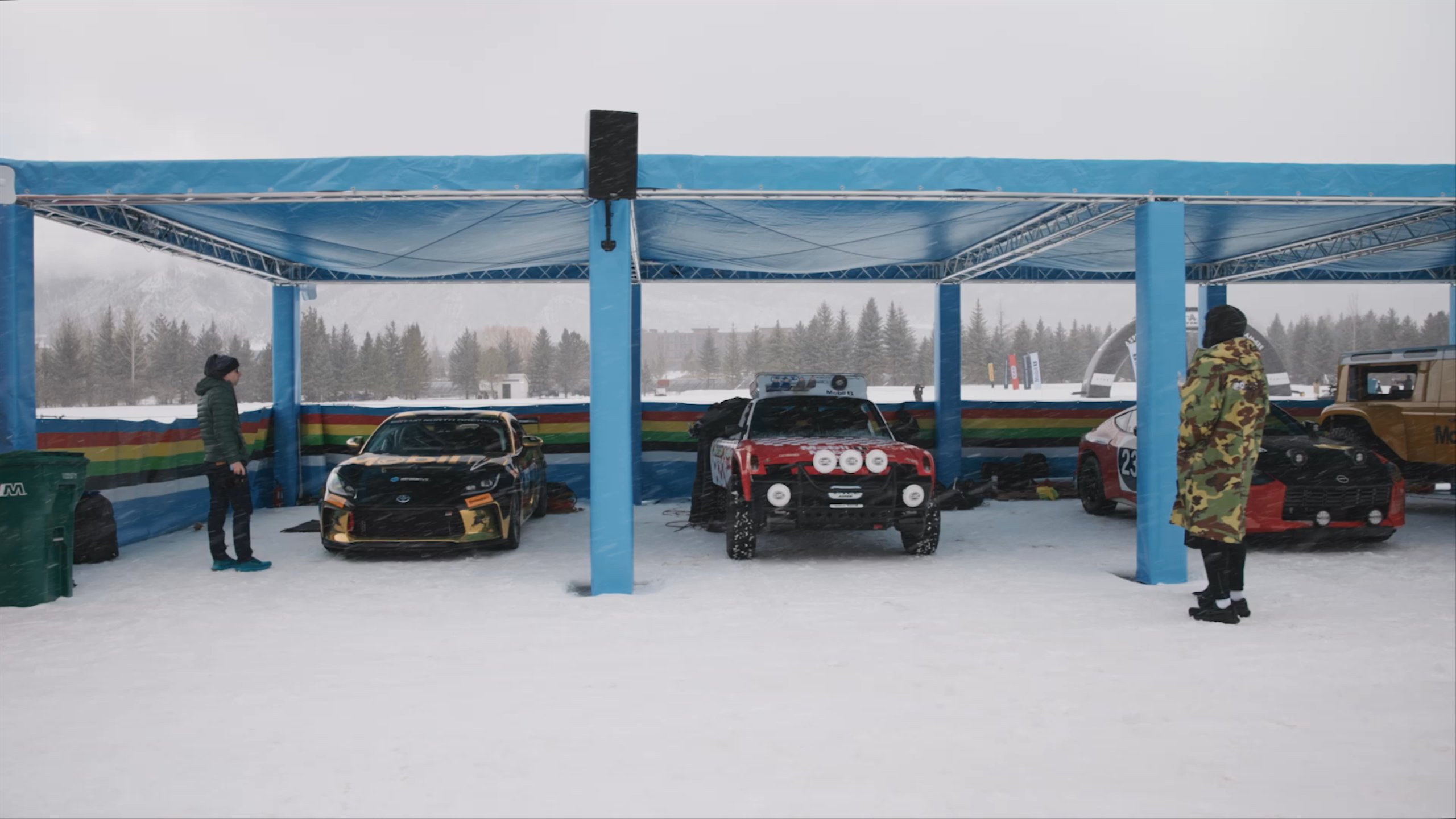 Panning view of various cars in the pit