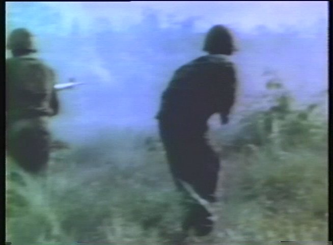 Historical footage of military helicopter operations and combat in Vietnam transitions to a present-day veteran surfing on ocean waves.