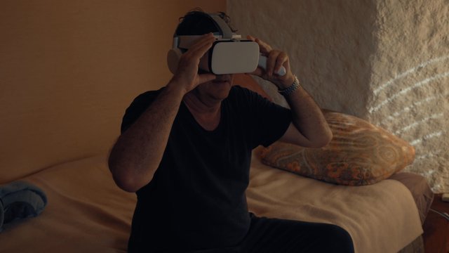 A man putting on VR glasses