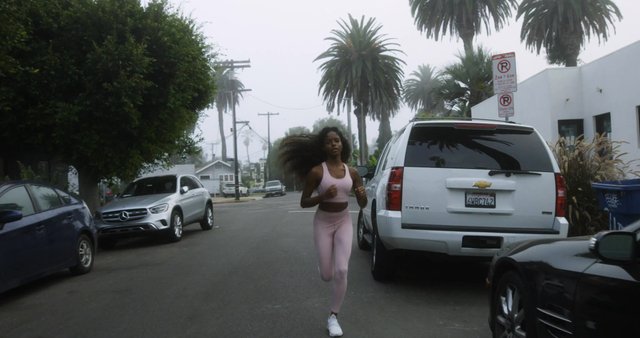 Woman jogging down the street