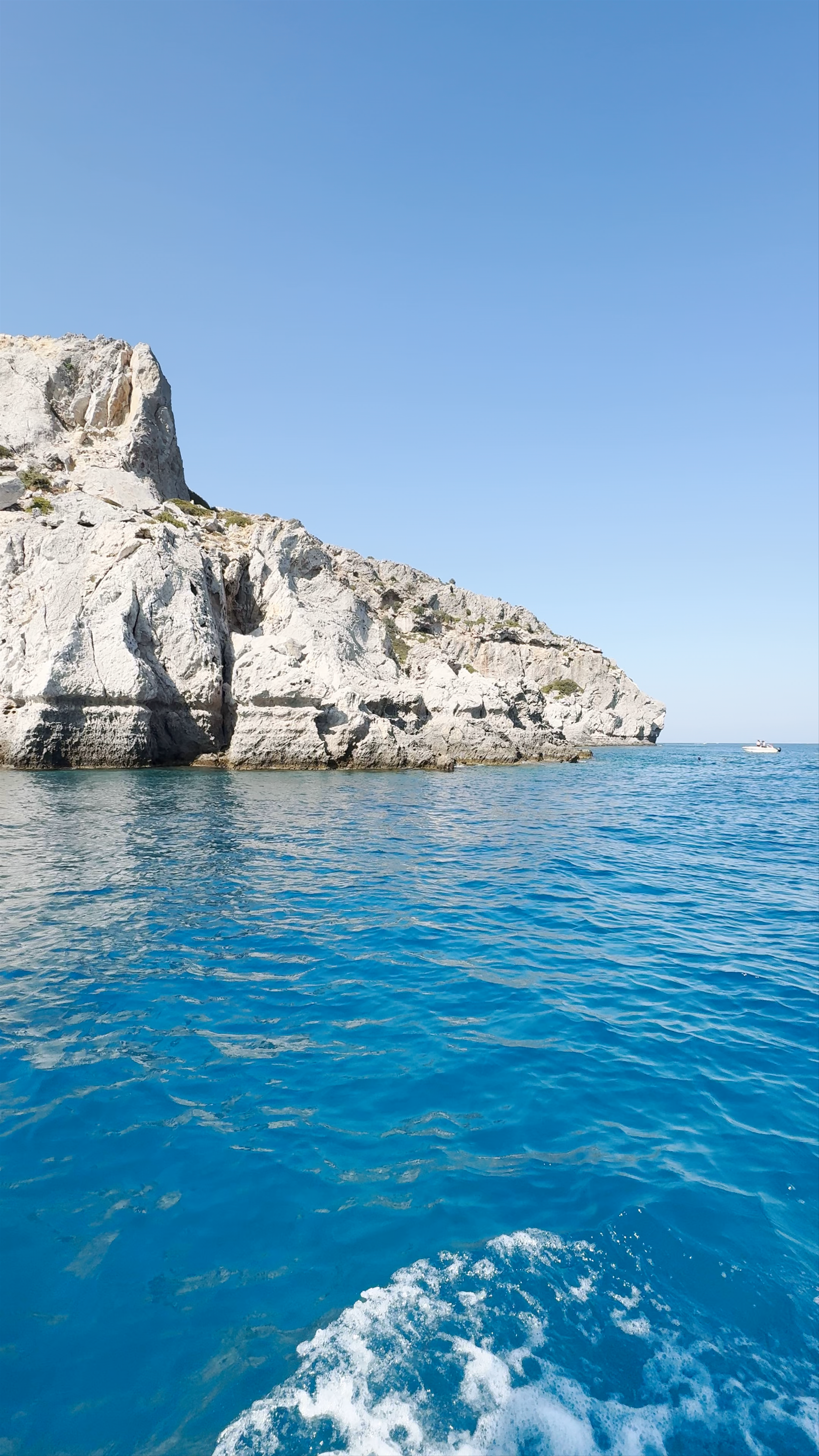 Traganou Beach: Crystal Waters and Rugged Cliffs in Afantou, Greece