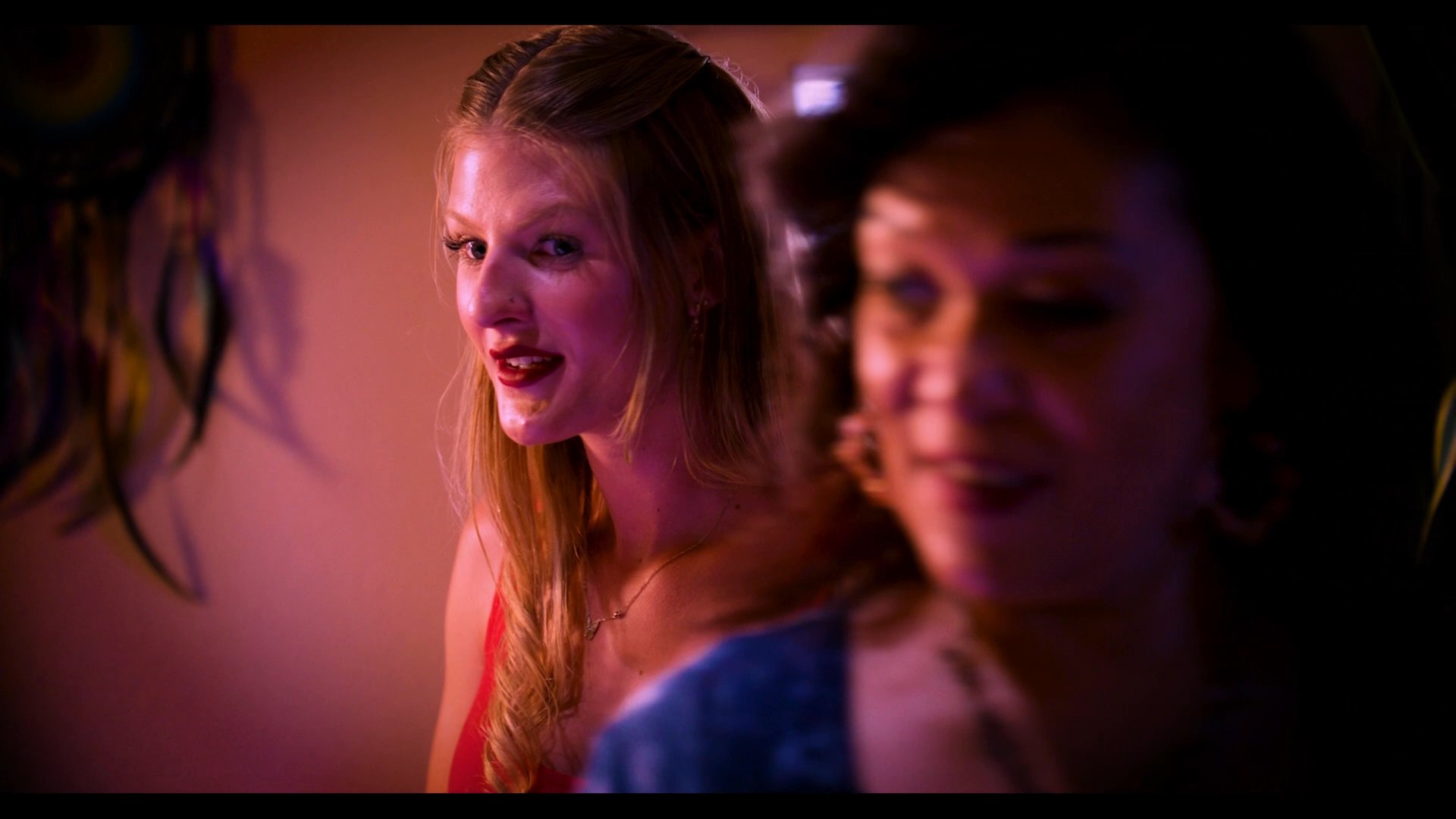 A woman participates in an interview for a dating program, interacting with other individuals and using visual aids in a controlled, studio-like environment.