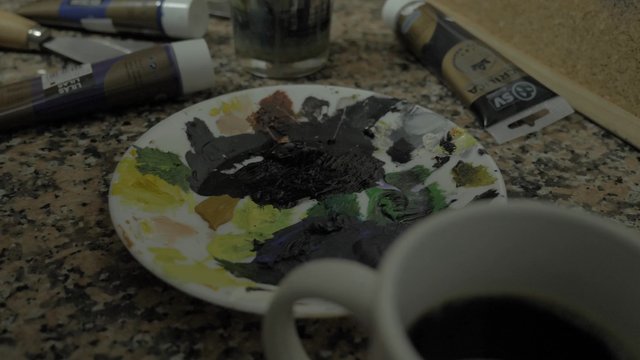 Artist rinsing a paintbrush