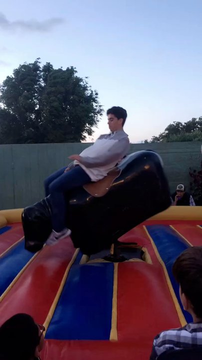 Los Socios - Riding the mechanical bull! - Bounce House Rentals Near Me