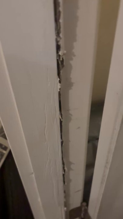 Invitation Homes - Up close on the door. Damages was painted over instead of fixed - Property Management Near Me - Sandy Springs, Georgia