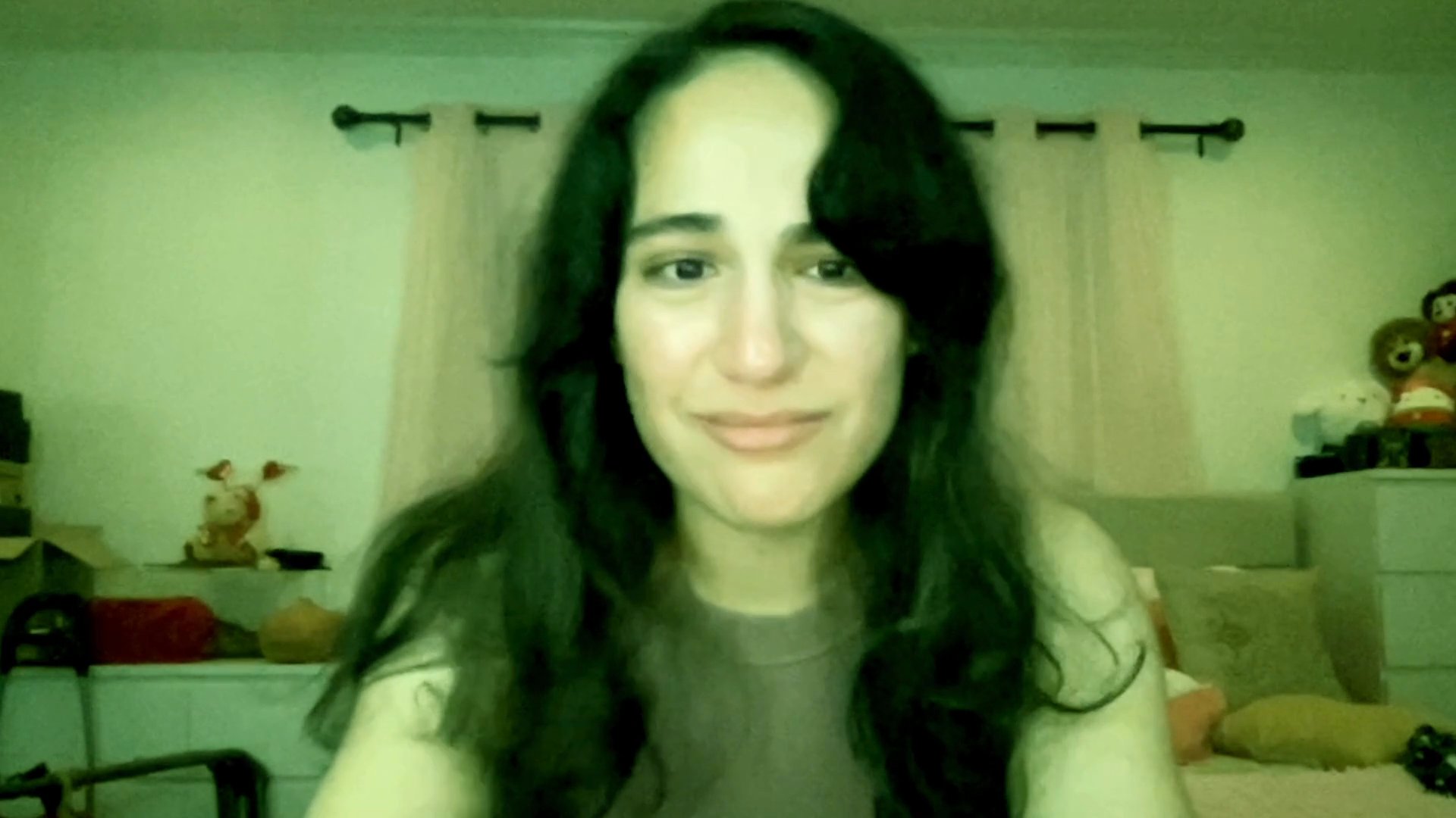 A woman shares an emotional, intimate personal story while speaking directly to the camera in her room. Her expressions shift between vulnerability, sadness, and optimism as she reflects on her current experiences.