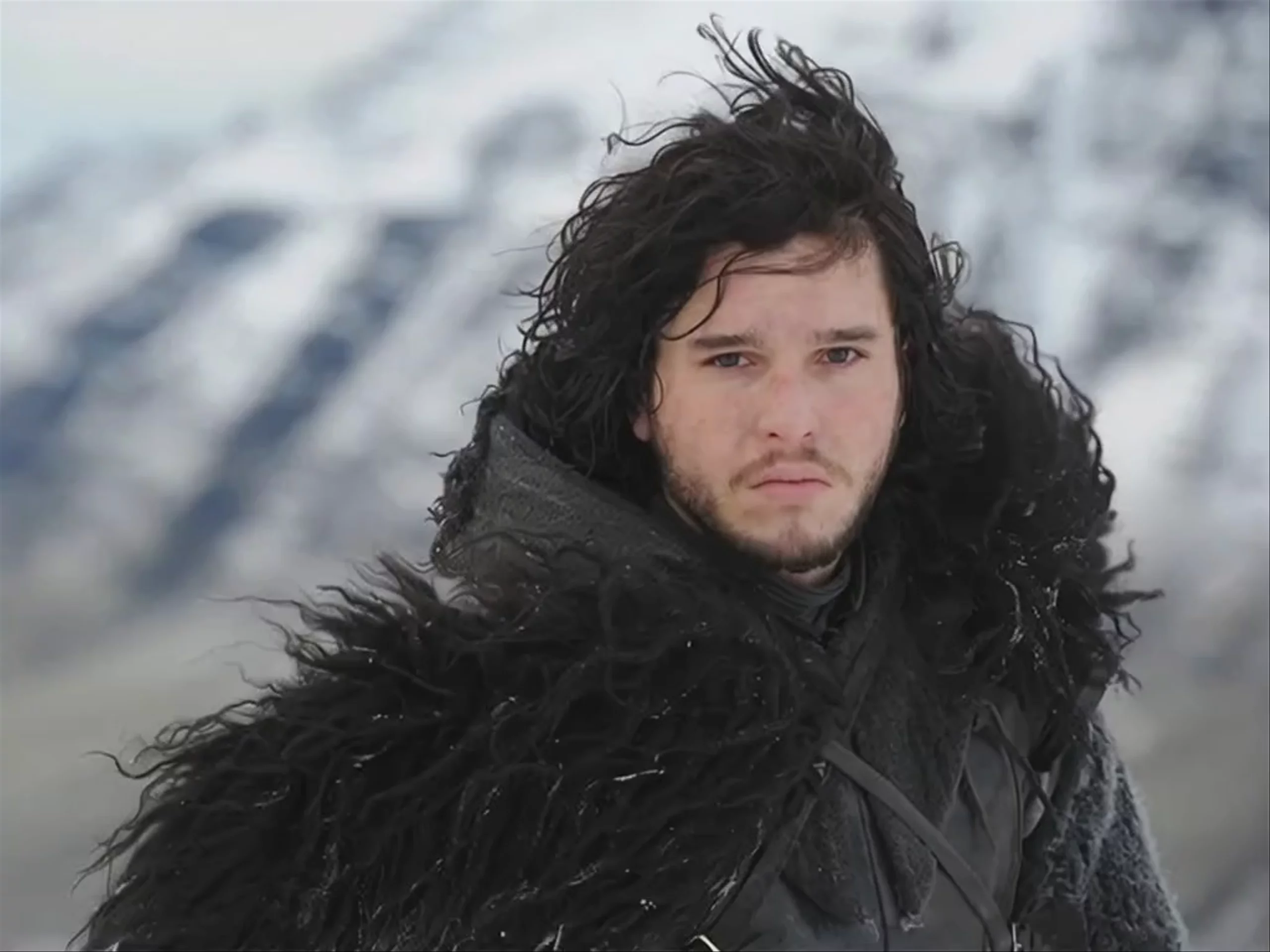 A close-up shot of a dark-haired man in a heavy black fur-trimmed cloak, standing against a backdrop of blurry, snow-covered mountains. Generated using MiniMax Hailuo 2.3 Fast Standard at a resolution of 1024x768, this video frame depicts a cinematic fantasy character with a serious expression.