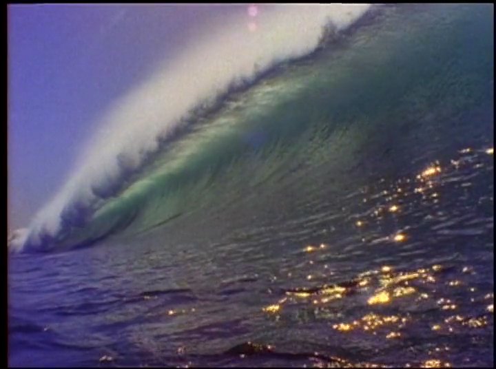 Surfer Fred Van Dyke discusses his experiences in the ocean, juxtaposing his personal reflections with archival footage of dolphins and powerful waves.