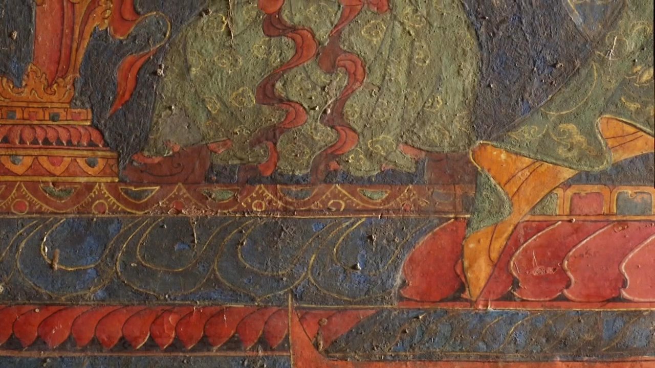 Artisans meticulously restore traditional religious frescoes within an historic monastery. The project involves close collaboration and precise painting techniques to preserve the intricate wall murals.