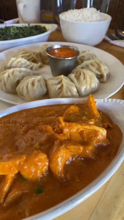 Sherpa Cafe - Chicken Momos in the back and Chicken Makhani in the front! Not pictured is their garlic naan and it's the best I've ever had in my life! - Indian Near Me - Crested Butte, Colorado